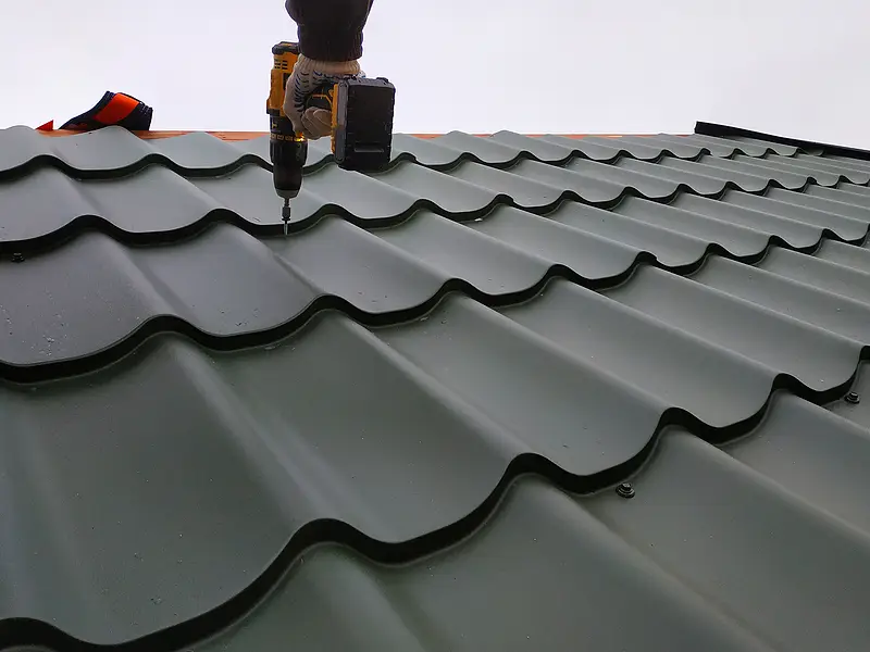 Drill fastening dark tile-profile metal roof panels during installation